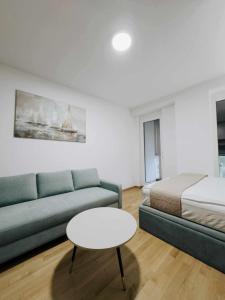 a living room with a couch and a bed and a table at Talevski D&T Apartment in Ohrid