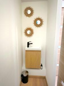 a bathroom with a sink and two mirrors on the wall at Superbe appartement moderne in La Valette-du-Var