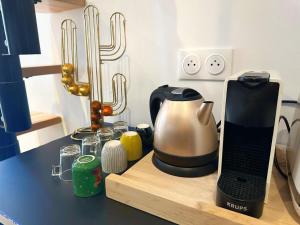 a kitchen counter with a coffee maker and a cactus at Superbe appartement moderne in La Valette-du-Var +3 photos