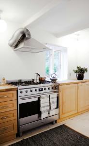 a kitchen with a stainless steel stove top oven at Renovated Estate With Private Beach in Roslev