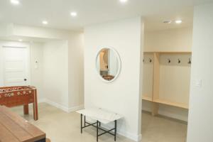 a room with a table and a mirror and a bench at Chalet Oasis - Spa and Incredible view in Saint-Philémon