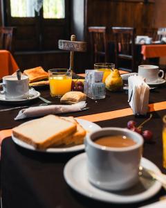 a table with sandwiches and a cup of coffee and toast at Casagrande Hotel de Adobe in Tinogasta