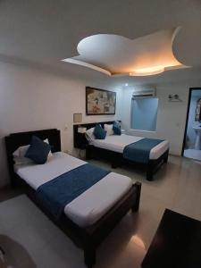 Voodi või voodid majutusasutuse Hotel Plaza Norte Cali toas