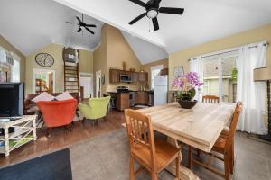 a kitchen and living room with a wooden dining room table at The Chicory - 4 Meadow View in Cherry Valley