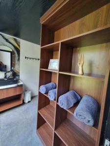 a book shelf with three towels in a bathroom at Happy Spiritus Guethouse Tabanan in Tabanan +63 photos