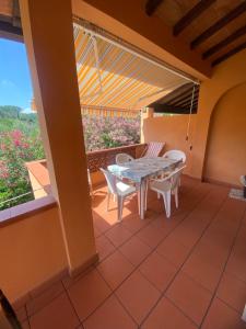 a patio with a table and chairs on a balcony at Appartamenti Anna in Rio Marina