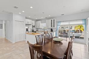 a kitchen and dining room with a table and chairs at Tipsy Turtle - Waterfront Pool Home, Direct Atlantic Access! in Marathon