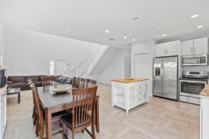 a kitchen and living room with a table and chairs at Tipsy Turtle - Waterfront Pool Home, Direct Atlantic Access! in Marathon