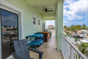 a balcony with a view of a marina at Tipsy Turtle - Waterfront Pool Home, Direct Atlantic Access! in Marathon
