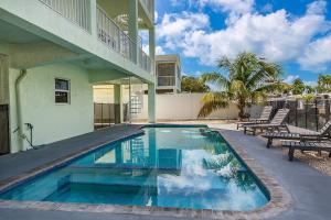 a swimming pool in front of a house at Tipsy Turtle - Waterfront Pool Home, Direct Atlantic Access! in Marathon