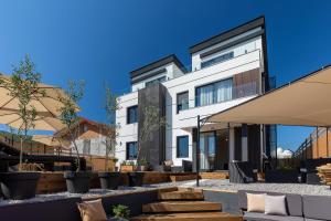 a large white building with a patio in front of it at Апартаменты с двумя спальнями и собственной террасой на крыше в доме с бассейном, возле пляжа Яз in Budva