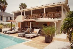 a villa with a swimming pool and a resort at Yucca mini boutique hotel - Adults only in Jan Thiel