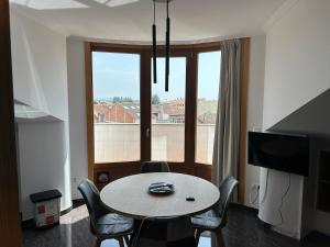 a dining room with a table and chairs and a window at Vista Santa Mariña in Cambados +28 photos