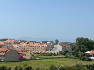 a group of houses with red roofs on a hill at Vista Santa Mariña in Cambados