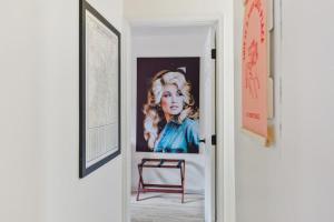 a painting of a woman on a wall next to a door at Pink Dreams - Walk to Live Music, Bars, Restaurants - Free Parking in Nashville