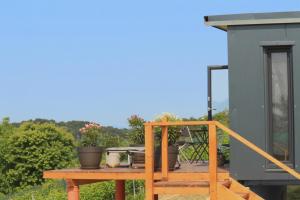 a balcony with a table with plants on it at Relaxing Tiny House with a beautiful view over the hills in Zagorje in Bedekovčina