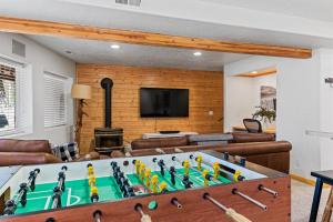 a living room with a pool table and a fireplace at Mallard Manor Hot Tub in Duck Creek Village