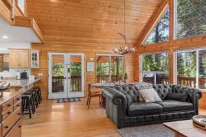 a living room with a couch and a table in a kitchen at Mallard Manor Hot Tub in Duck Creek Village