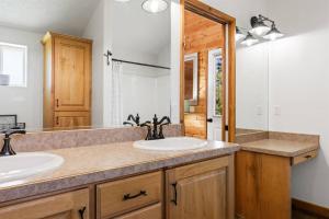 a bathroom with two sinks and a mirror at Mallard Manor Hot Tub in Duck Creek Village +23 photos