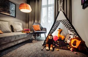 a childs room with a crib with stuffed animals at Leonardo Boutique Hotel Krakow Old Town in Kraków