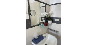 a bathroom with a sink and a mirror at Villa Anna in Messina +43 photos