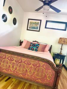 a bedroom with a bed with a ceiling fan at HOUSE OF ROCK - DOWNTOWN, RUPP ARENA, KEENELAND, HORSE PARK in Lexington