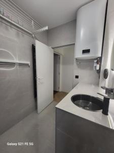 une petite cuisine avec un évier et un réfrigérateur dans l'établissement Grand T2 Cours Napoleon B, à Ajaccio 38 autres photos