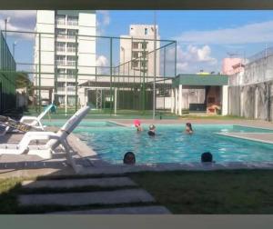 a group of people in a swimming pool at Apartamento cop 30 ainda será mobiliado in Ananindeua