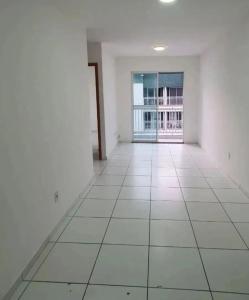 Habitación vacía con paredes blancas y ventana grande. en Apartamento cop 30 ainda será mobiliado, en Ananindeua 2 fotos más