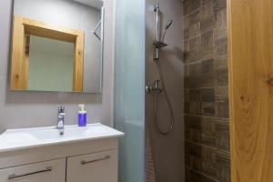a bathroom with a sink and a shower at Motel Aqua Kozarac in Kozarac +45 photos