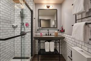a bathroom with a sink and a mirror at Moxy Dublin Docklands in Dublin +31 photos