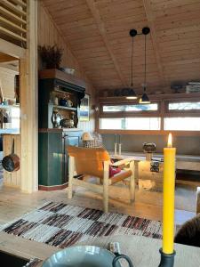 a living room with a table and a kitchen at Furuly Cabin At Sangefjell, Peace And Nature in Ål