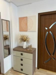 a room with a dresser and a wooden door at Studio 1 & Studio 2 Aqua in Eforie Nord