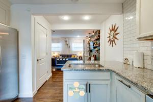 a kitchen with a sink and a living room at The Nashville Diamond in Nashville
