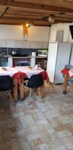a kitchen with a table with chairs and a refrigerator at La Casa de Teresa in Colonia del Sacramento +21 photos