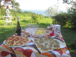 a picnic table with food and a bottle of wine at Agriturismo Belvedere in Bolsena