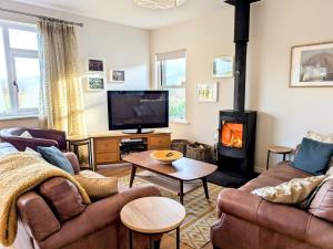 a living room with couches and a wood stove at 2 Bed in Bassenthwaite SZ381 in Bassenthwaite Lake