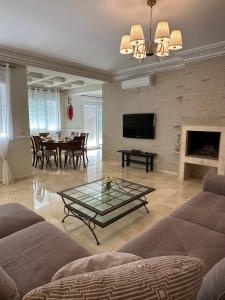 a living room with a couch and a table at Asilah VIP - Sea view & Swimming Pools - Garage Private in Asilah