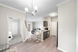 a kitchen and living room with a sink and a table at Houston Lakeside Living in Houston