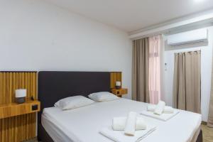 a bedroom with a large bed with two white pillows at Motel Aqua Kozarac in Kozarac
