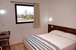Ένα ή περισσότερα κρεβάτια σε δωμάτιο στο JF Hotel Nova Aliança +32 φωτογραφίες