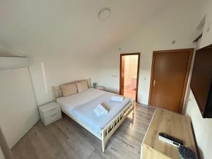 Postel nebo postele na pokoji v ubytování Markovi Apartments