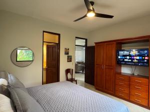 a bedroom with a bed and a ceiling fan at Casa Suerte in Coco