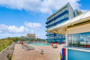 a resort with a swimming pool and a building at Coconut Palms Beach Resort II 4512 in New Smyrna Beach