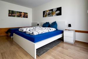 a bedroom with a blue and white bed with blue pillows at Zentrale Wohnung in St. Moritz mit großem Balkon in St. Moritz