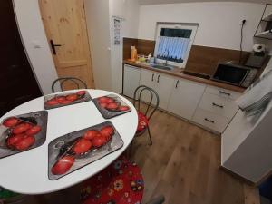 a kitchen with a table with tomatoes on it at DOMEK Łapalice Kaszuby in Łapalice +12 photos