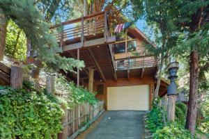 a house with a balcony and a garage at Retro Cabin in Lake Arrowhead