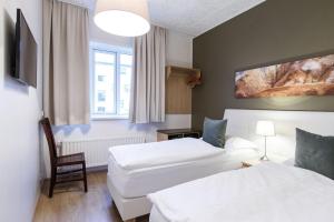 Postel nebo postele na pokoji v ubytování Centrum Hotel