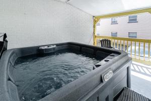 a hot tub on top of a balcony at Old-Time Charm - 12 Guests - Billiards & Hot Tub in Sainte-Anne-de-Beaupré