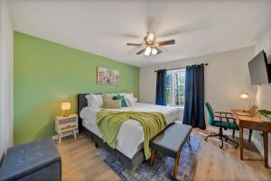 a bedroom with a bed with a ceiling fan and a desk at The Nestle 3-Bed 2-Bath Chapin - Near Lake Murray in Chapin
